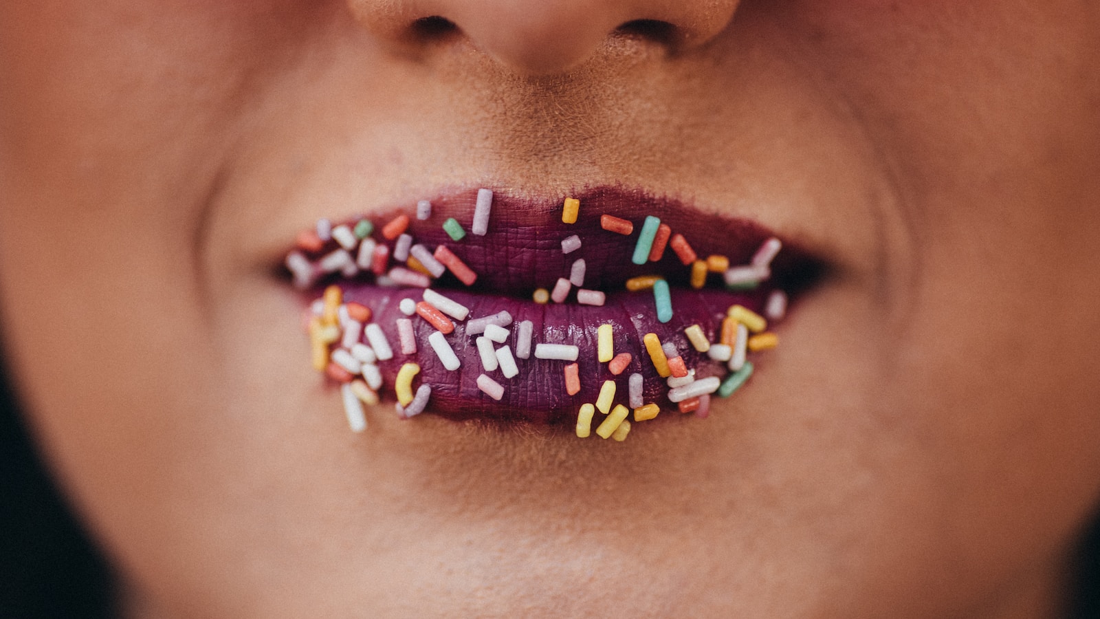 lip with purple lipstick and sprinkles
