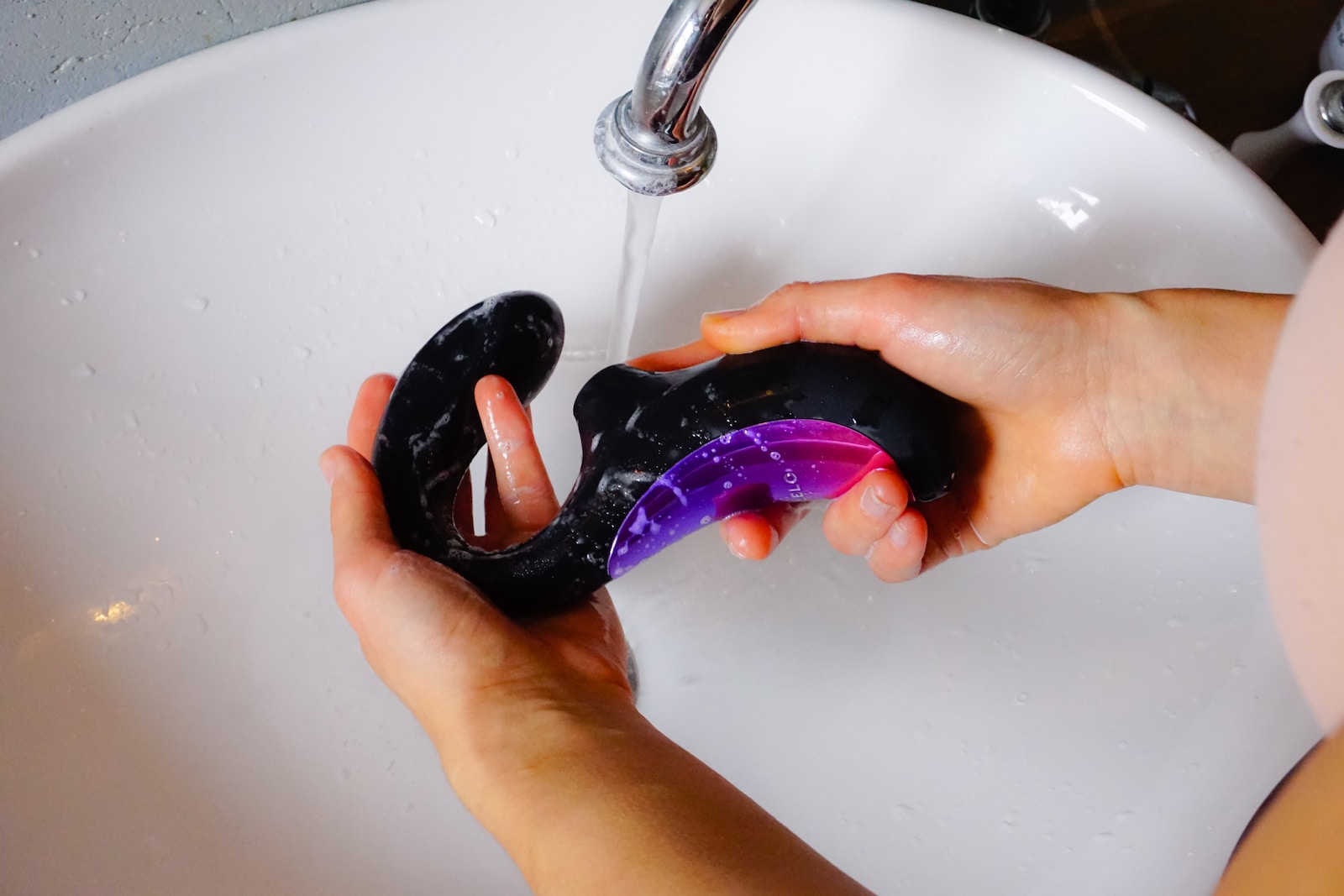 person holding black and purple cordless game controller